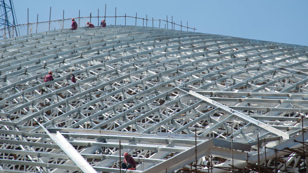 People work on the steel structure of the National Stadium, San Jose, Costa Rica.