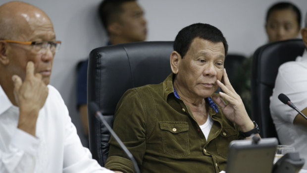 Philippine President Rodrigo Duterte, centre, and Defence Secretary Delfin Lorenzana, left, attend a command briefing on typhoon Mangkhut.