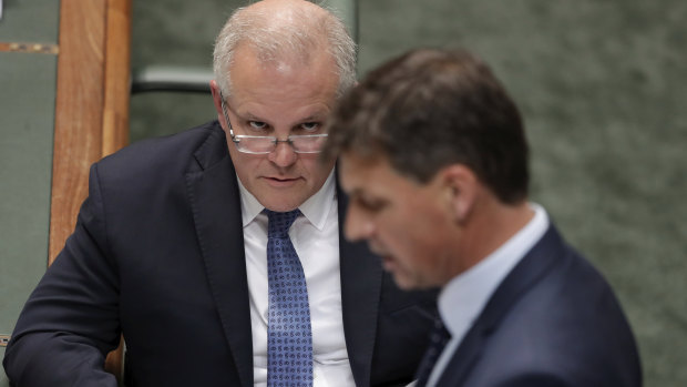 Prime Minister Scott Morrison listens as the Minister for Energy and Emissions Reduction, Angus Taylor, responds to a question on Thursday. 