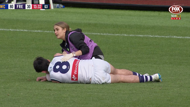 Andrew Brayshaw on the Optus Stadium turf after the hit.