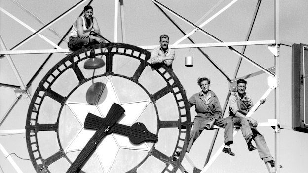Workers paint and clean the Feltex Clock on the Rowan Bond building in Sydney in 1946.