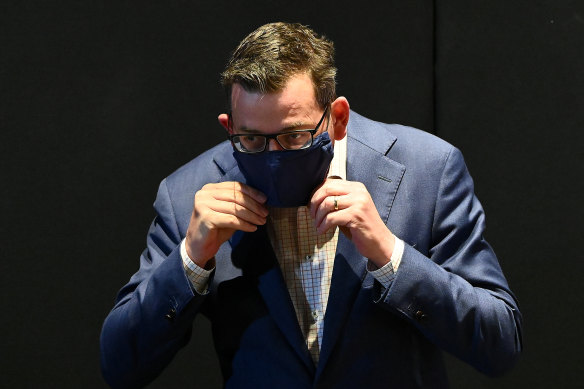 Victorian Premier Daniel Andrews puts on a face mask after fronting the media on Monday.