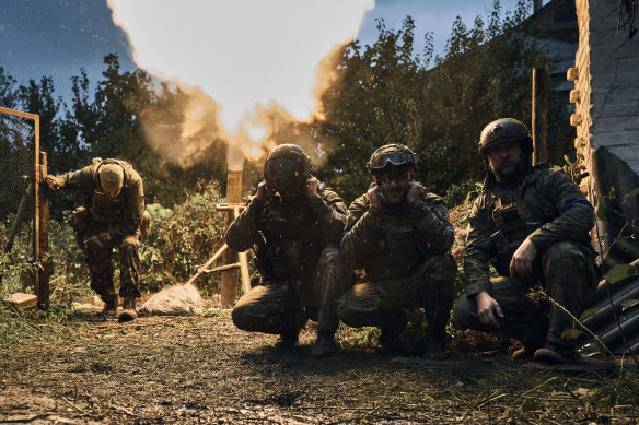 Ukrainian soldiers fire in the recently retaken Kupiansk in the Kharkiv region, Ukraine.