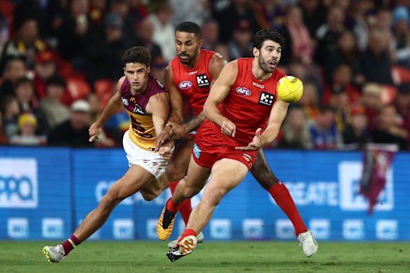 Christian Petracca of the Suns handballs.
