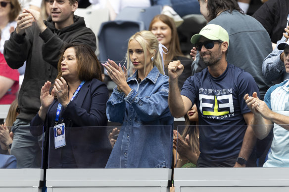 Morgan Riddle (centre) watching partner Taylor Fritz take on Fabian Marozsa at the Australian Open on Friday.