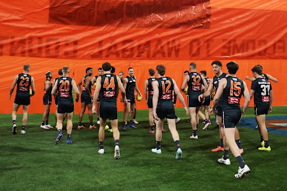 The Giants run through their banner during the round 20 AFL match against the Sydney Swans.