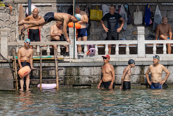 Men take a dip in the canal just outside the Summer Palace grounds in Beijing.
