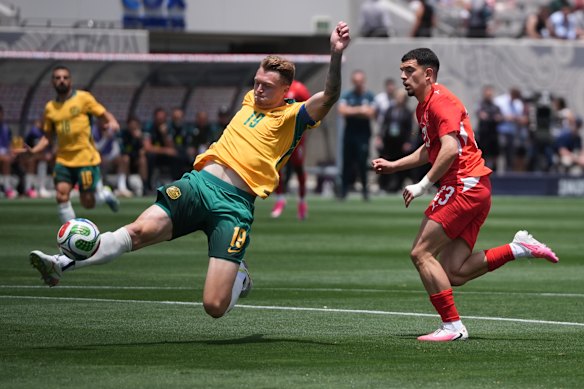 Australia defender Harry Souttar clears the ball.