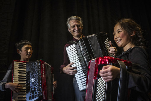 Anthony Schulz, centre, with Accordion Society of Australia Victoria Orchestra members Louis and Victoria Wu.
