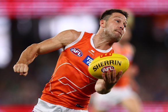 Toby Greene prepares to fire off a handball.