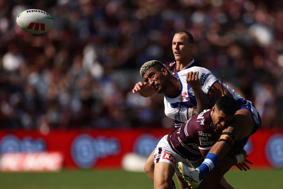 Star Bulldogs recruit Viliame Kikau gets crunched by the Manly defence.