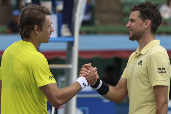 Australia’s Alex de Minaur, left, shakes hands with Austria’s Dominic Thiem after de Minaur won their match at the Kooyong Classic on Tuesday. 