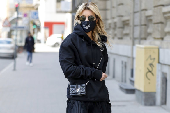 German influencer Gitta Banko wears a face mask printed with the words "get ready to breath better" in Dusselford on March 21. 