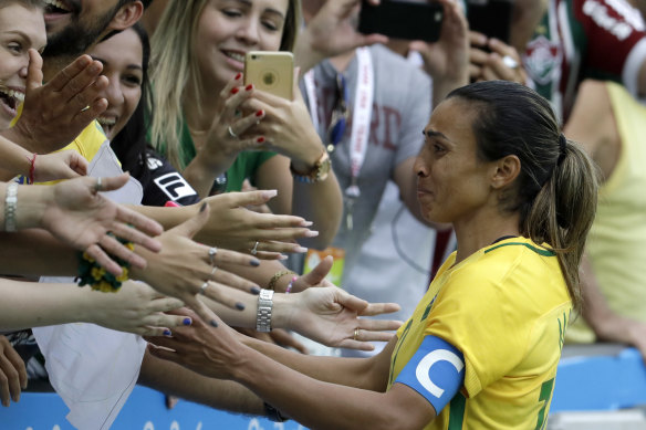 Marta is comforted by fans after Brazil’s Rio Olympics semi-final loss to Sweden at the Maracana.