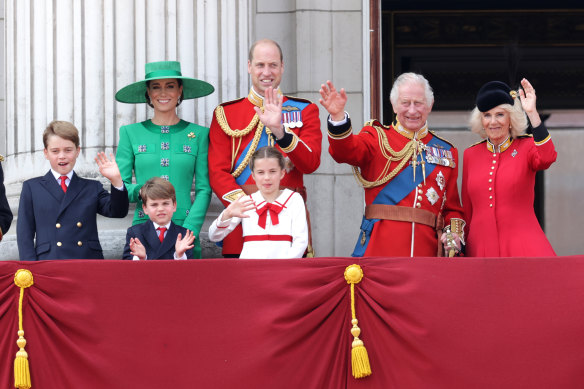 King Charles and Queen Camilla wave alongside Prince William, Prince Louis, Princess Charlotte, Catherine, Princess of Wales and Prince George on the Buckingham Palace balcony.
