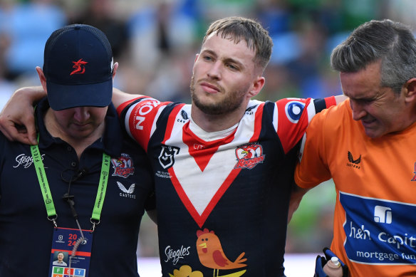 Sam Walker is helped off the field after suffering a ruptured ACL against Canberra.