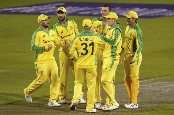 Australia's Josh Hazlewood, third right, celebrates with teammates the dismissal of England's Moeen Ali during the first ODI cricket match between England and Australia, at Old Trafford in Manchester, England.
