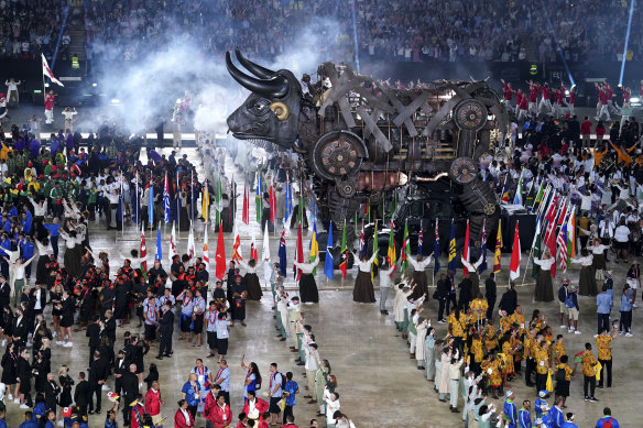 Athletes gather around a raging bull during the opening ceremony.