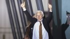 Julian Assange gave two thumbs up as he stepped off the plane to applause in Canberra on Wednesday night.