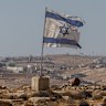 An Israeli flag flies along a highway near the settlement of Carmel in the West Bank.