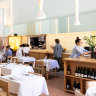 The dining room is high-ceilinged, strung with ceramic lights as delicate as paper.