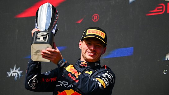 Race winner Max Verstappen of the Netherlands celebrates on the podium. 