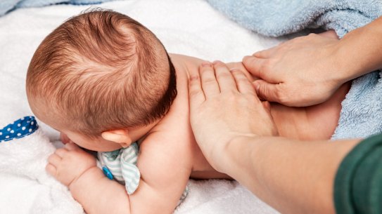 Baby receives manual therapy at home.