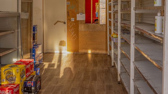 The Red Shop’s shelves might be empty but business is brisk through the window at the rear.
