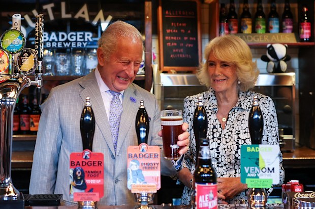 King Charles III enjoys a pint next to Queen Camilla in the Hall and Woodhouse Badger Brewery bar as the brewery celebrates its 250th anniversary on July 16, 2026 in Blandford Forum, England