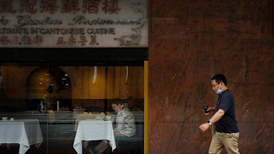 A man walks past a restaurant in Sydney’s Chinatown. In Melbourne, restaurants are counting down the days until they too can open their doors. 