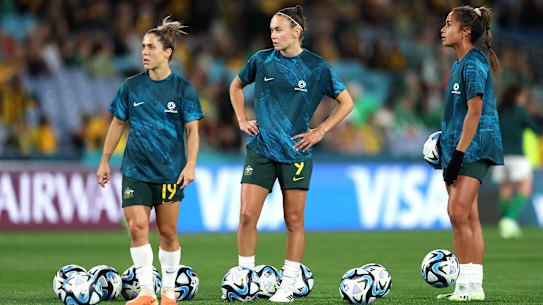 Mary Fowler (right) prepares to partner with Caitlin Foord (centre) in attack during the warm-up before the Matildas’ opening match against Ireland.