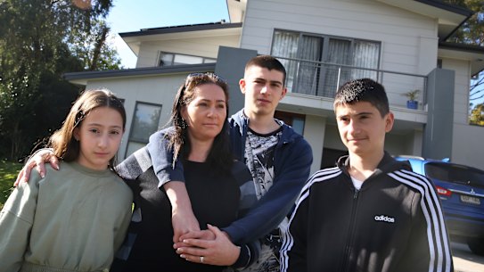Katherine Maiorca and her children (L to R) Imogen (12) Nicholas (16) and Sammy (14) in front of their family home in Sutherland which has had major defects during its construction. 