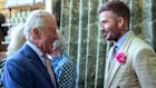 David Beckham wearing a “King’s Rose” speaks with King Charles at the Chelsea Flower Show.