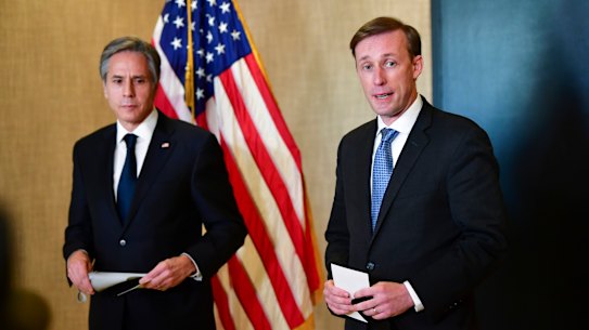 Secretary of State Antony Blinken, left, listens as National Security Adviser Jake Sullivan, right, talks to the media after a closed-door morning session of US-China talks in Anchorage.