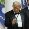 Donald Trump holds a sabre after using it to cut a cake, as Vice President J.D. Vance looks on, at the Commander-in-Chief Ball, part of the 60th Presidential Inauguration. 