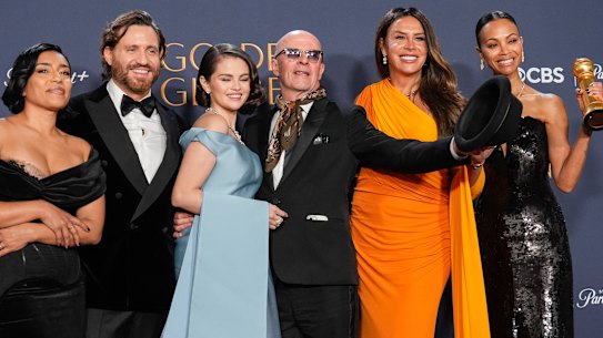 Adriana Paz (from left) Edgar Ramirez, Selena Gomez, Jacques Audiard, Karla Sofia Gascon, and Zoe Saldana with the award for best motion picture - musical or comedy for Emilia Perez.