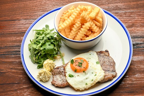 Most mains are served with crinkle cut chips, like this pastrami-crusted minute steak.