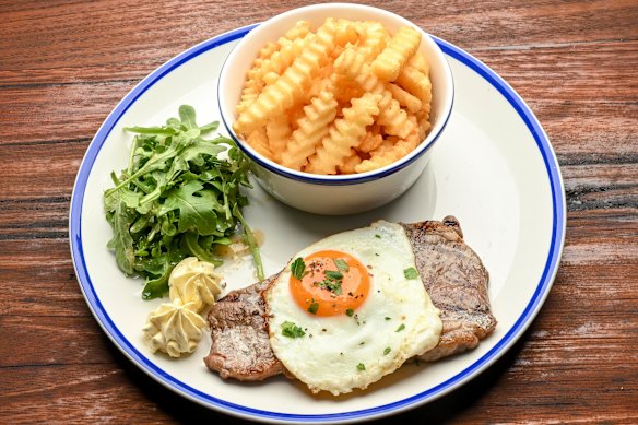 Most mains are served with crinkle cut chips, like this pastrami-crusted minute steak.