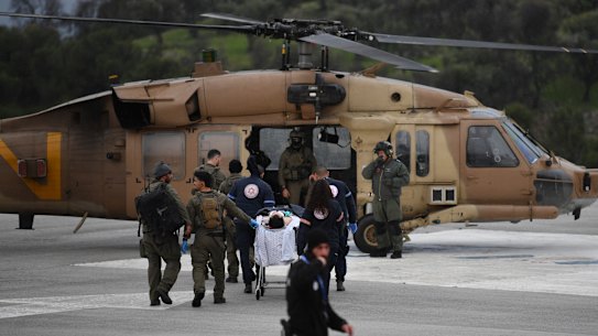 An Israeli medical team evacuate a person injured by a rocket fired from Lebanon, at Ziv hospital in Safed, northern Israel, Wednesday, Feb. 14, 2024. Israeli media reported 1 killed and eight wounded in the rocket attack. The town, which is around 12 kilometers (7 miles) from the border is farther south than most of the daily border skirmishes with Lebanon’s Hezbollah militant group. (AP Photo/Gil Eliyahu)