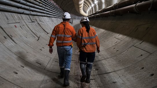 Abdalah El Sayed and engineer Jaime Cheuk walk down the Sydney metro tunnel. 
