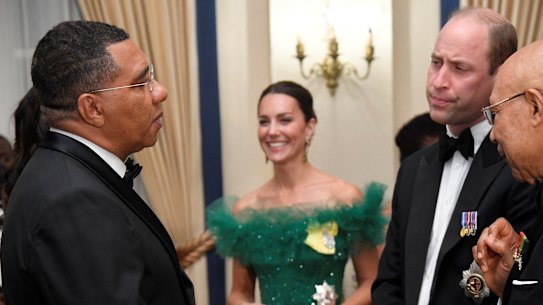 From left, Jamaican Prime Minister Andrew Holness, Catherine - the Duchess of Cambridge - Prince William and Governor-General of Jamaica Patrick Allen speak during a dinner at King’s House in Kingston.