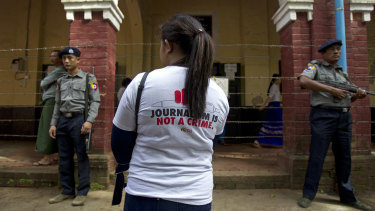 A journalist stands outside the court during the trial of Reuters journalists Wa Lone and Kyaw Soe Oo, who were sentenced to seven years in prison. 