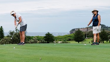 From a distance: Rosie Millington (in white) with golf partner Marg Novaro practicing putting at Mona Vale Golf Club.