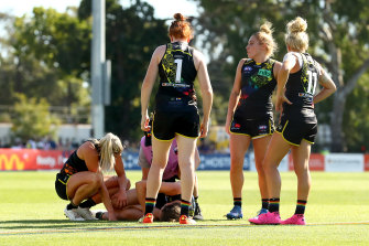 Harriet Cordner receives medical attention following a collision during round three. 