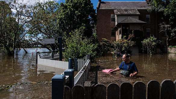 Windsor residents wading through their flooded property last week.