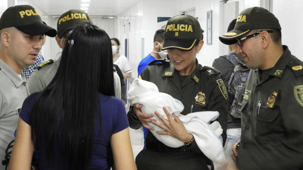 Colombia National Police, officers arrive to a hospital with an abandoned newborn baby girl who was discovered swaddled by a car near a stadium in Cucuta, Colombia.