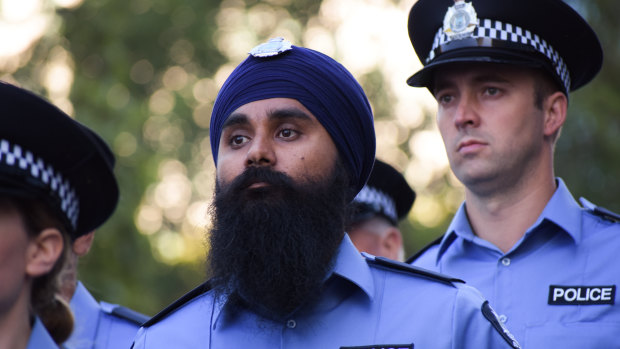 Police officer Jasvir Minhas marches down St Georges Terrace in company of fellow officers. 