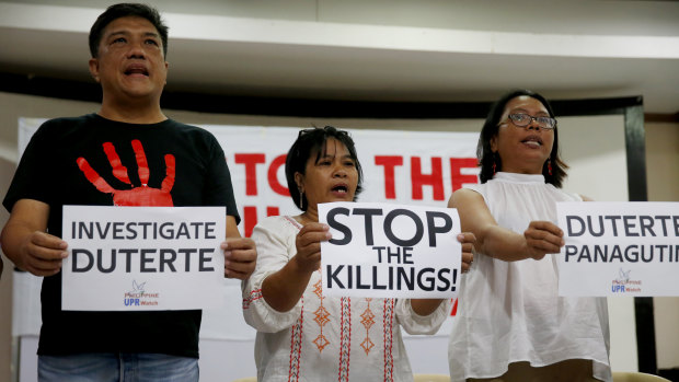 Human rights advocates display placards during a news conference in suburban Quezon city, northeast of Manila, following the United Nations Human Rights Council's resolution in Geneva.