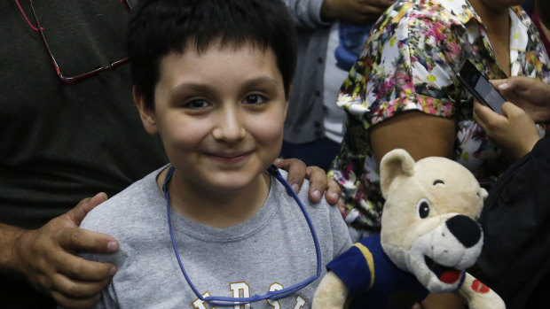 12-year-old Carlos Santamaria Diaz smiles as he stands with his parents during a press conference at Mexico's National Autonomous University in Mexico City.