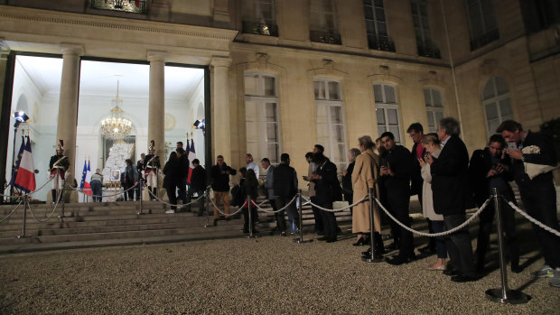People line up to sign the condolences book to pay tribute to former President Jacques Chirac at the Elysee Palace on Thursday.